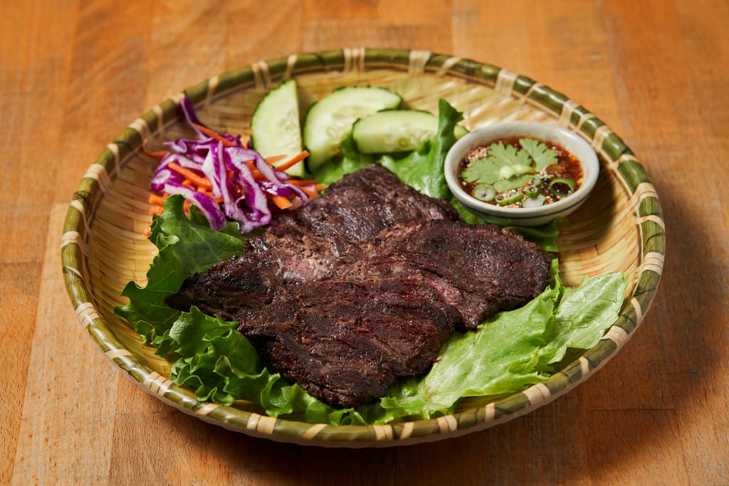 Thai grilled beef with vegetables and dipping sauce at a NYC Thai restaurant