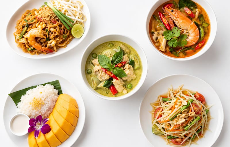 Top Thai dishes to try in New York featured food spread on white table