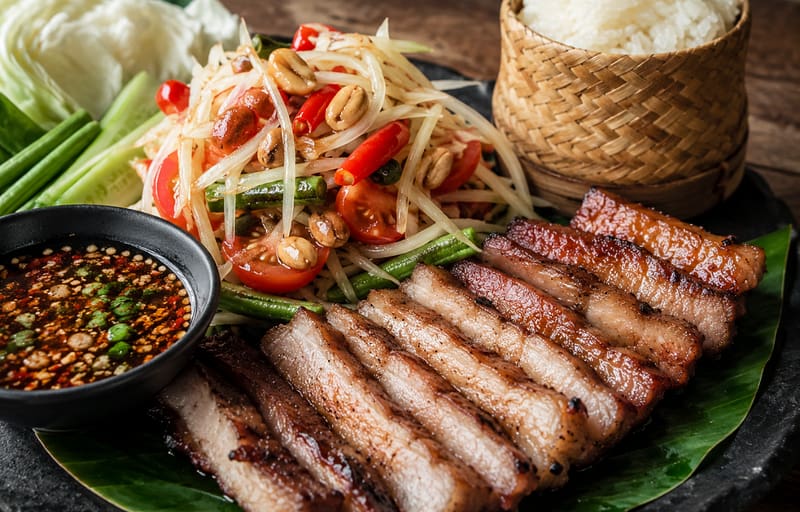 Moo Yang Som Tum with Thai grilled pork papaya salad and sticky rice
